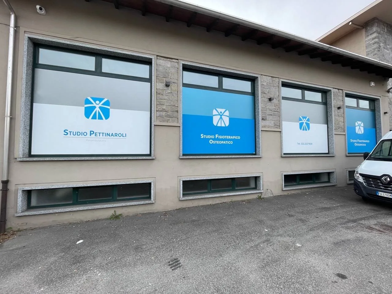 Finestre dello Studio Pettinaroli coperte dalle grafiche azzurre su tutta la facciata